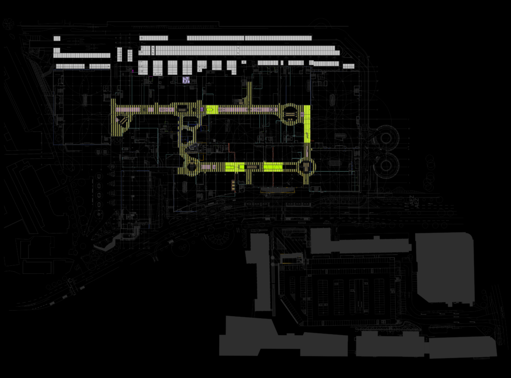 CAD floor plan drawing of a shopping mall level with retail unit layouts, highlighted corridors, and exterior parking.