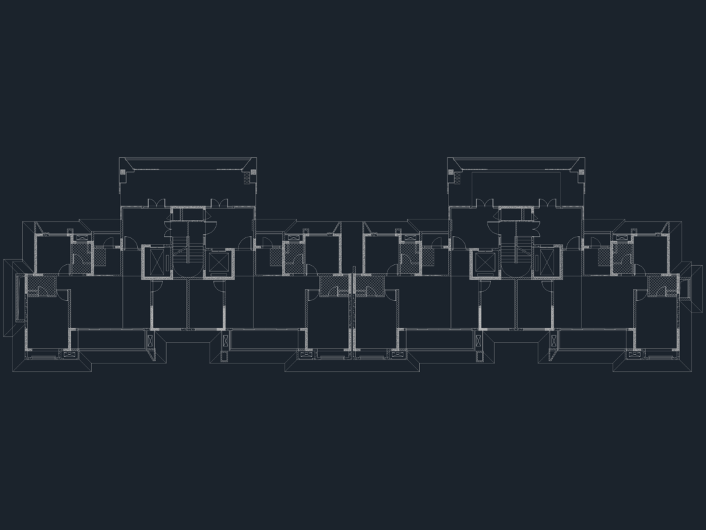 Architectural floor plan showing symmetrical residential units with central stairs, elevators, and balconies.