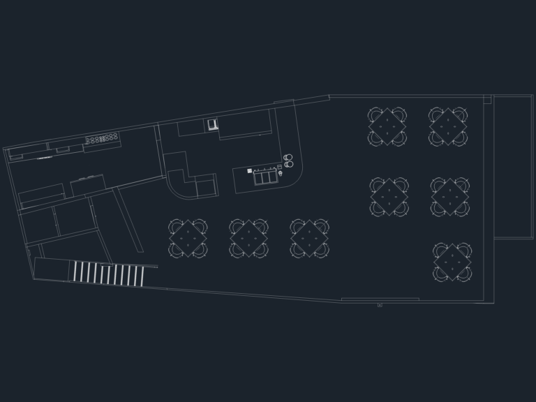 Wedge-shaped CAD floor plan for a small cafe showing kitchen equipment, bar counter, seating area, and staircase.