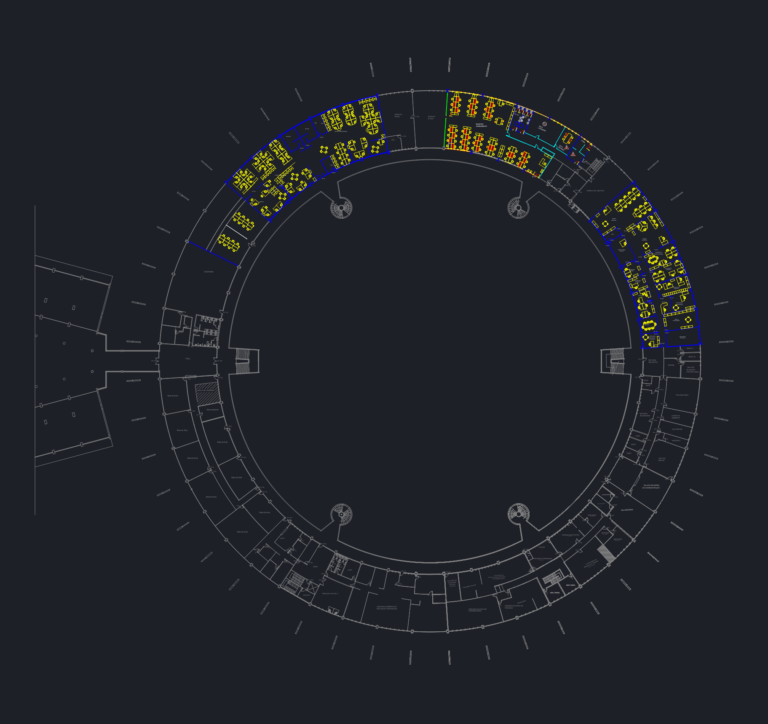 CAD floor plan of a large circular building with a central void, office furniture layouts, and administrative wings.