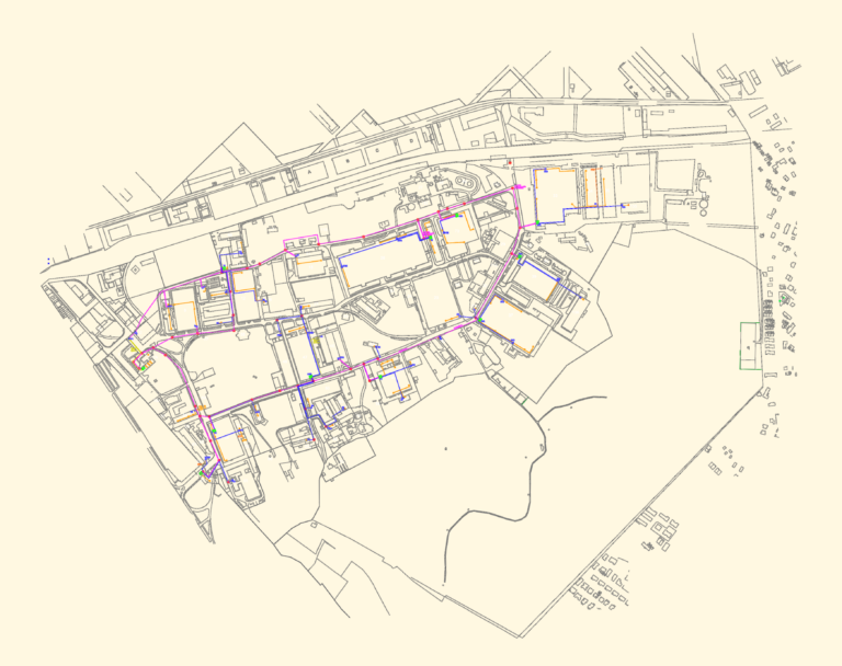 Telecom site plan showing an optical fiber network layout with colored infrastructure lines over a building complex.