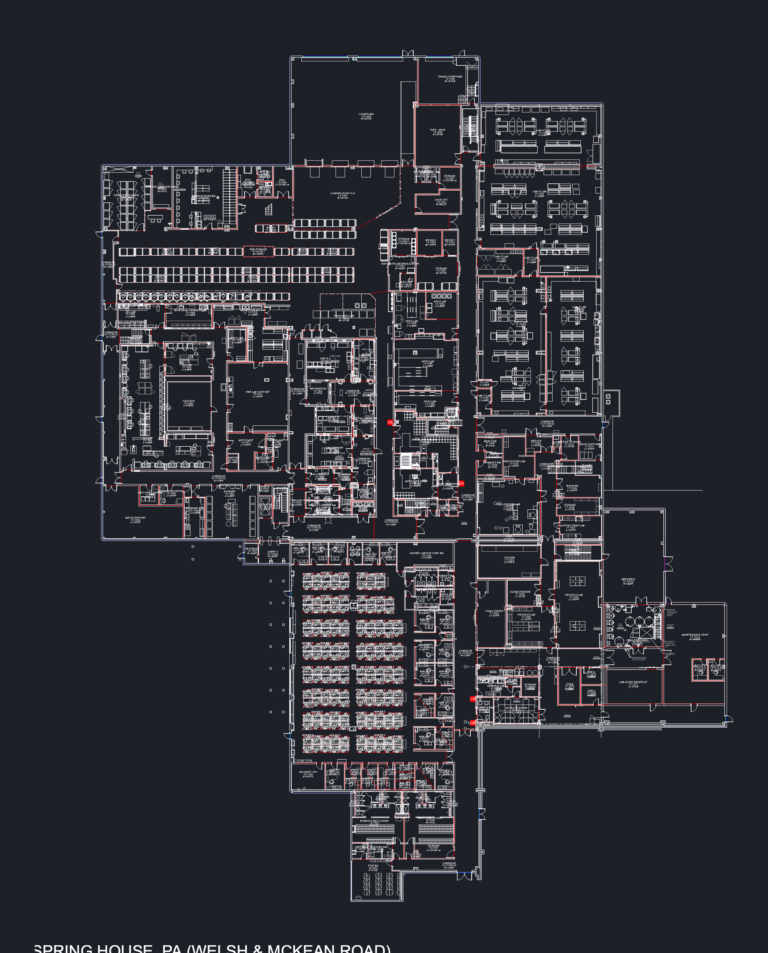CAD floor plan of an industrial manufacturing and lab facility showing office layouts, loading docks, and laboratory zones.