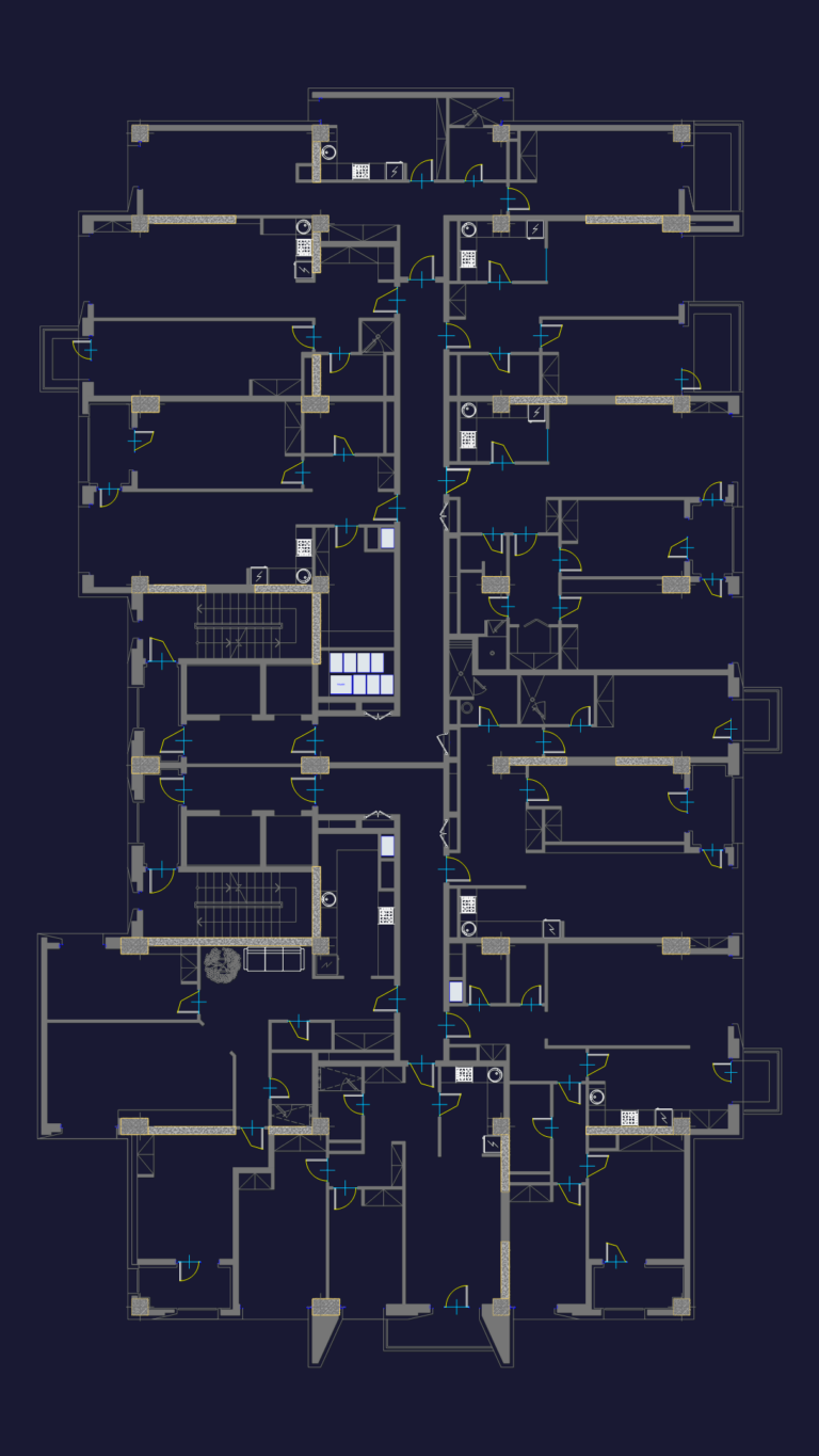 CAD floor plan of a multi-unit apartment complex showing central corridor, two stairwells, and structural column grid.