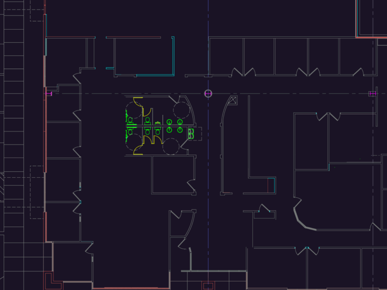 Architectural floor plan of a commercial office space showing offices, restrooms, and a structural grid.