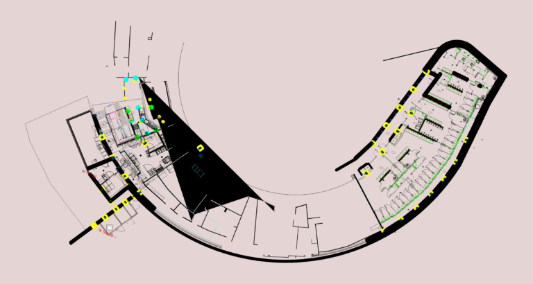 Floor plan of a commercial kitchen and large public restroom facility with equipment and drainage.
