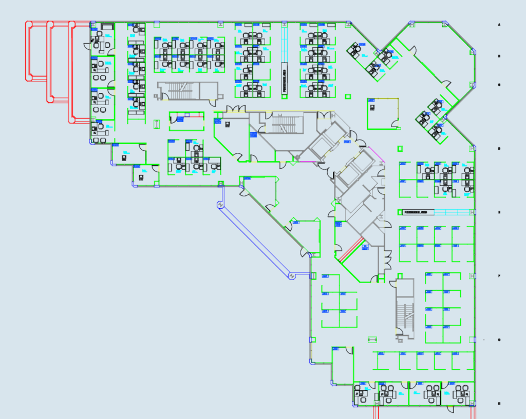 2D CAD floor plan of a corporate office with cubicles, desks, stairs, and structural grid lines.